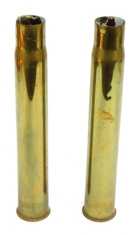 Two brass shell cases, one stamped A No 97, and the other stamped F9, each 37cm high, 4.5cm diameter. (2)