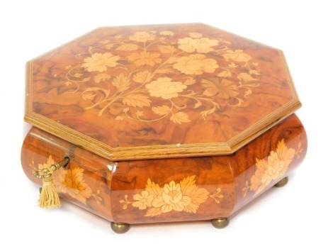 An Italian octagonal topped music box, the floral panel on brass bun feet, 9cm high, 23cm wide, with key.