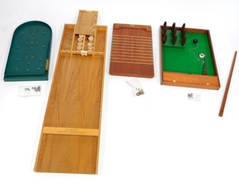 A group of vintage games, to include a Jacques board, a shove halfpenny Jacques board, and a table skittles. (4)