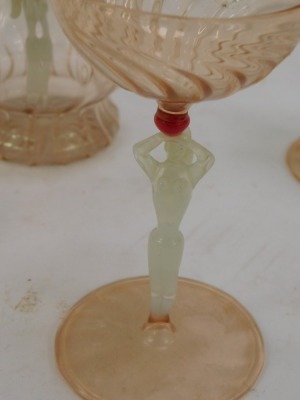 A Venetian pink glass decanter and stopper, the interior set with a female figure and three matching glasses. - 2