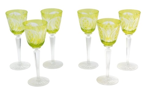 A set of crystal wine glasses, each with a yellow etched bowl, on faceted stem, 21cm high.