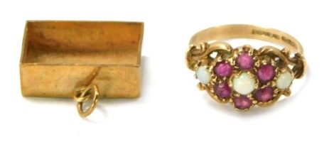 A 9ct gold dress ring, set with garnets and opals in cross over setting, size M½, and a 9ct gold framed charm, lacking interior, 4.9g all in. (2)