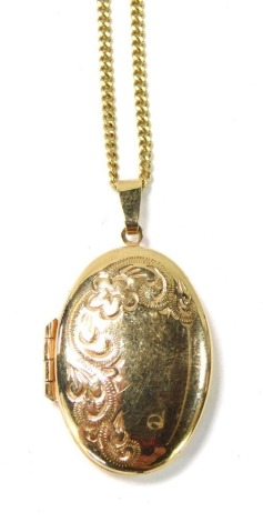 A locket and chain, comprising a gold plated locket with floral engraving, on a small curb link neck chain, stamped 375, 60cm long, 8.5g all in.