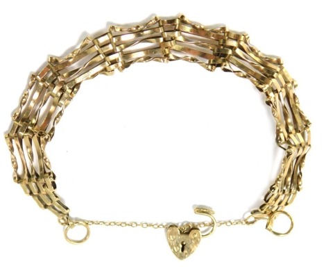 A 9ct gold bar bracelet, of five bar design with safety chain and heart shaped padlock, 16cm long, 7.4g all in.