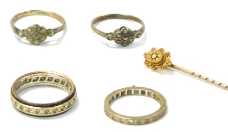 A group of jewellery, comprising a 9ct gold and seed pearl topped stick pin, a silver eternity ring, a silver and two marcasite dress rings, and silver and 9ct gold eternity ring, 10.9g all in. (5)