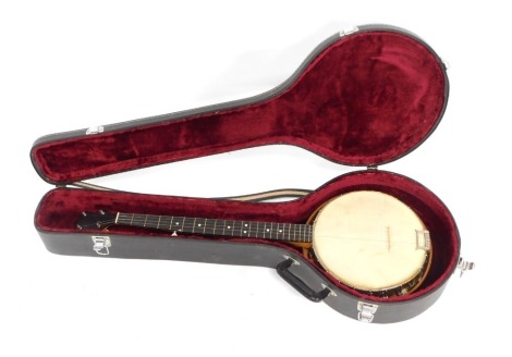 An Apollo banjo, with a beech reeded case, with mother of pearl points, and bone tuning pegs, in fitted case, 90cm long,