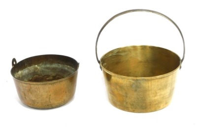 A large Victorian brass fixed iron handle cooking pan, 33cm diameter, and another. (2)