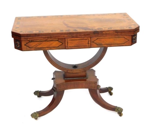 A 19thC Regency mahogany and coromandel card table, with canted corners and fold over top, with green leather inset, on shaped support and cabriole legs, on claw feet terminating in castors, 72cm high, 90cm wide, 44cm deep.