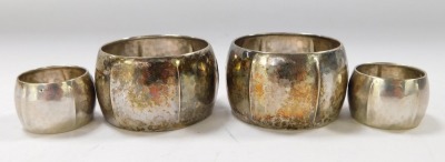 Four hammered napkin rings, comprising two large and two small white metal, stamped 800, 9¼oz, in K Compaan boxes. - 2