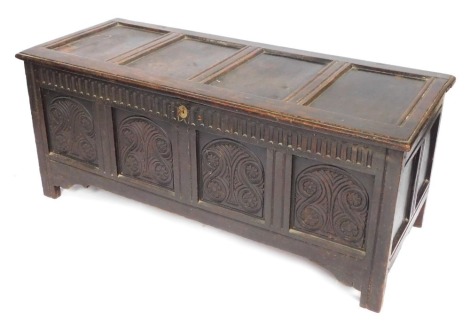 An early 18thC oak carved coffer, four panels, on reeded stiles, 62cm high, 148cm wide, 59cm deep.