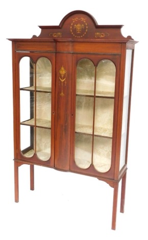 An Edwardian mahogany cabinet, with transfered Neo Classical turned urns and swags and lined shelves on tapered legs, 180cm high, 106cm wide, 32cm deep.