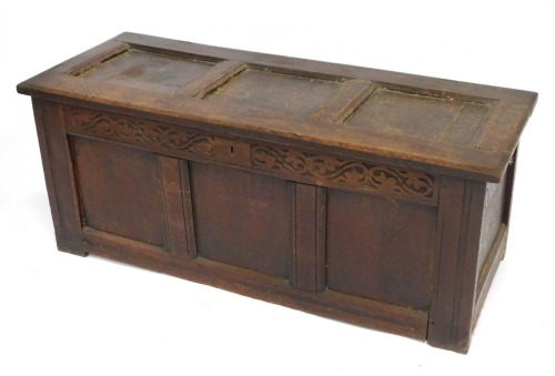 An 18thC oak coffer, with lock plate and scroll design, with three panels, reduced, 48cm high, 116cm wide, 48cm deep.