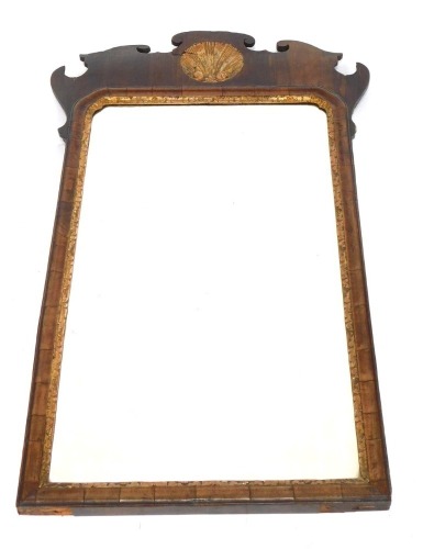 A George III mahogany fret framed wall mirror, in applied gilt shell detail, 93cm high, 54cm wide.