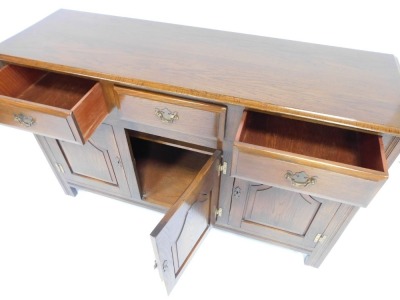 An oak sideboard, with three drawers and three cupboard doors on styles, 83cm high, 135cm wide, 43cm deep. - 2