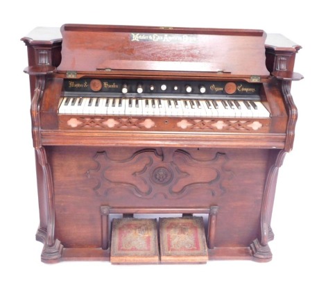 A Metzler & Co American walnut harmonium, stamped for The Mason & Hamblin Organ Company, 110cm high, 116cm wide, 58cm deep.