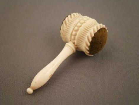 A miniature carved ivory gavel in the form of a pin cushion with