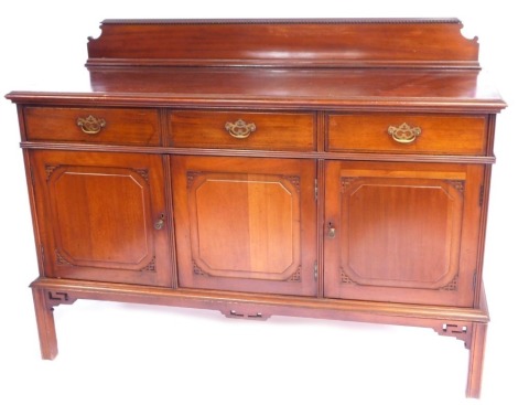 A 20thC mahogany sideboard, with a raised gallery back, above three drawers and three cupboards, with fret carved supports, on tapered legs, 110cm high, 160cm wide, 60cm deep.