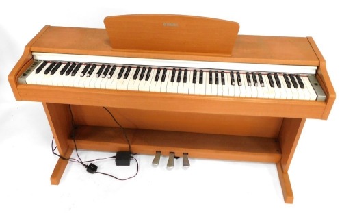 A Yamaha YDP-131 electric keyboard, in beech case, 80cm high, 134cm wide, 42cm deep.