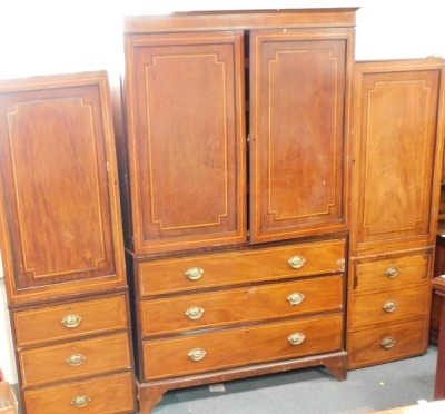 A 19thC mahogany cross banded wardrobe, the central section with two swing doors over three long drawers, on bracket feet with moulded cornice, and two associated single pine panels with door and three drawers, label for Amy Kesteven, the central section - 2