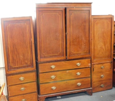 A 19thC mahogany cross banded wardrobe, the central section with two swing doors over three long drawers, on bracket feet with moulded cornice, and two associated single pine panels with door and three drawers, label for Amy Kesteven, the central section - 3