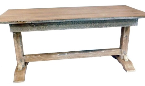 A limed oak refectory table, on plain end supports, in Heals style, 80cm high, 184cm wide, 74cm deep.