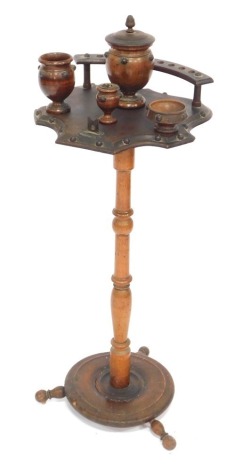 A walnut smoker's stand, with applied star finials, and a rack and jar stand, on a turned column on tripod base. (AF)