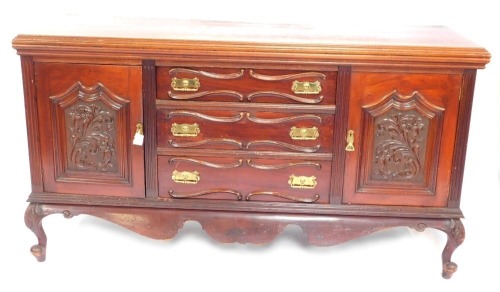 An Edwardian walnut sideboard, with a moulded cornice back above an arrangement of three drawers and two cupboard doors, each with applied carved detail on ball and claw feet, 110cm high, 182cm wide, 60cm deep.