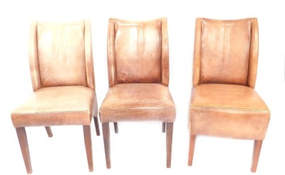 A set of three leatherette dining chairs, upholstered in light brown. (AF)