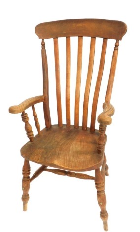 A 19thC ash and elm grandfather chair, with a solid seat on turned legs.