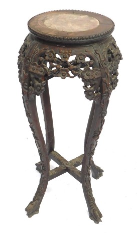 A Chinese hardwood plant stand, with marble inset circular top, and carved horse splayed legs, 80cm high, 28cm wide.