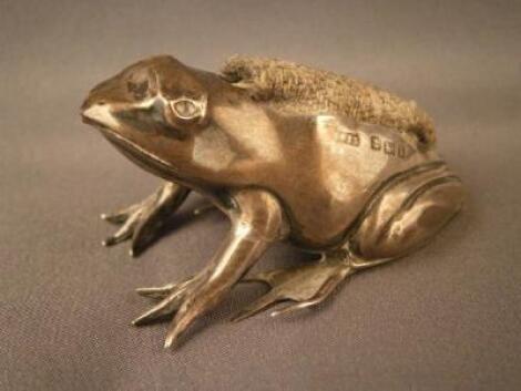 A silver pin cushion in the form of a seated frog