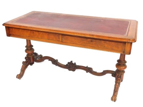 A 19thC walnut writing table, with two drawers, on cabriole scroll legs, with a red leather inset top, 73cm high, 136cm wide, 65cm deep.