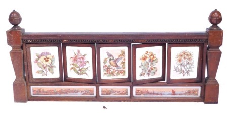 A Victorian aesthetic walnut and glass painted bed end, with square set painted panels depicting Geisha and buildings, 66cm high, 153cm wide, 10cm deep.