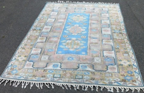 An eastern rug, with a design of three medallions, in pastel colours, 278cm x 207cm.