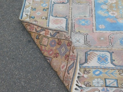 An eastern rug, with a design of three medallions, in pastel colours, 278cm x 207cm. - 3