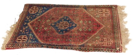 A Persian rug, on a blue, red and cream ground, with central medallion and four borders, 97cm x 63cm.