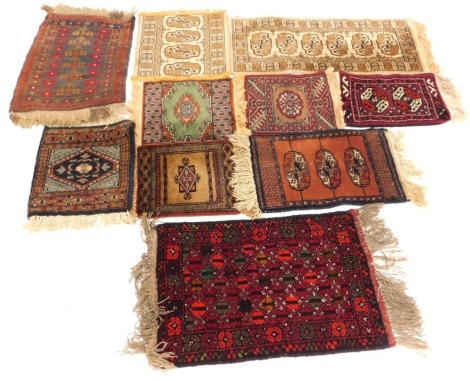 A collection of mats and rugs, each of varying design, 30cm x 30cm, 30cm x 29cm, 36cm x 30cm, 43cm x 30cm, 53cm x 37cm, 58cm x 42cm, 35cm x 24cm, 30cm x 29cm, together with two silk backed rugs, 38cm x 34cm and 70cm x 33cm respectively. (10)