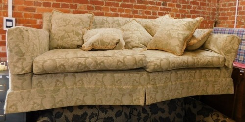 A Duresta style two seater sofa, with a shaped front, with cream vase and flower design, 235cm wide, 80cm high, 97cm deep.