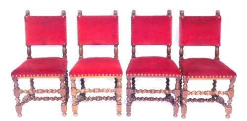 A set of four oak dining chairs, red velvet with button detail on barley twist columns. (4)