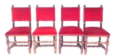 A set of four oak dining chairs, red velvet with button detail on barley twist columns. (4)