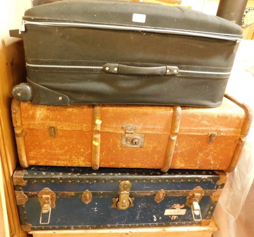 Trunks and cases, comprising a modern black material case, a tan bound trunk, and a blue canvas lined trunk. (3)