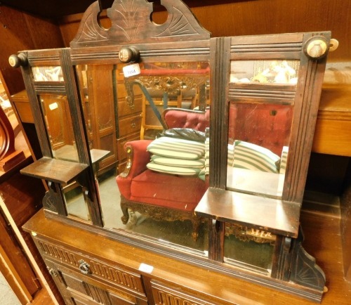 A 1920's oak hanging rack, with mirrored shelf panels and prints of nude ladies.