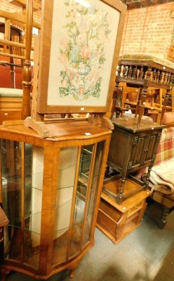 A walnut display cabinet, the curved frontage with two shelves, on out splayed legs, together with tapestry fire screen, piano stool, oak cupboard and a magazine rack. (5)