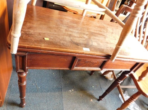 A 19thC mahogany fold over tea table, with a figured panel to the centre on turned tapering legs, 75cm high, 88cm wide, 44cm deep.