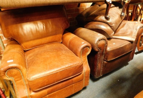 Two leather armchairs, comprising a brown leather studded armchair and a tan leather armchair. (2)