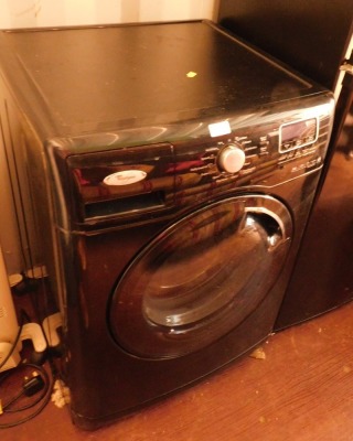 A Whirlpool Six Sense washing machine, black.