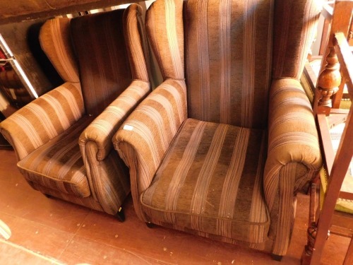 Two brown wingback armchairs.