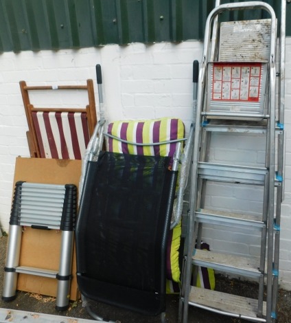 A striped deck chair, two outdoor chairs, pasting table, two aluminium step ladders and a telescopic extending ladder. (7)