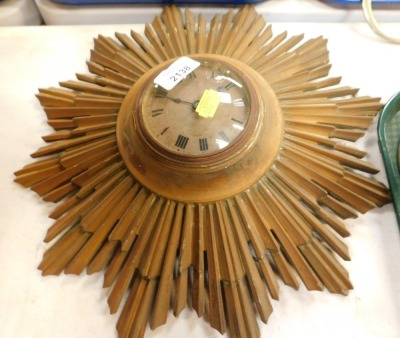 A gilt metal sunburst clock with Buren movement and Roman numeric dial.