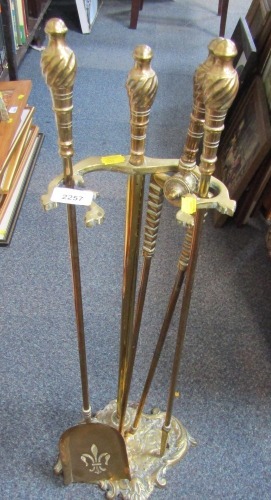 A 20thC brass fireside set, with leaf moulded base, with four implements.